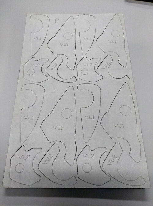 Backside of the Poron gasket pad with adhesive. Part numbers are scribed into each part for ease of assembly at the tier supplier