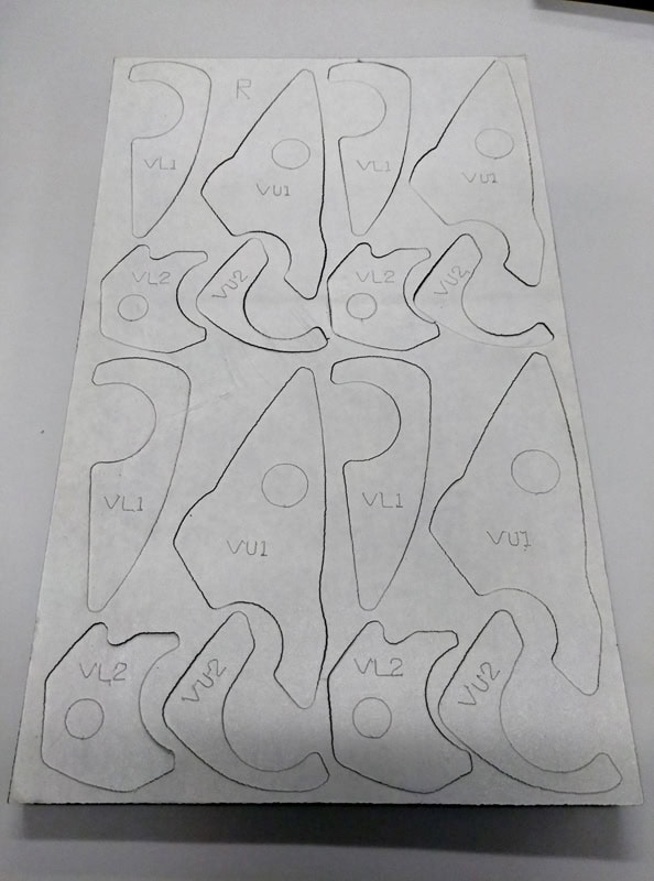 Backside of the Poron gasket pad with adhesive. Part numbers are scribed into each part for ease of assembly at the tier supplier